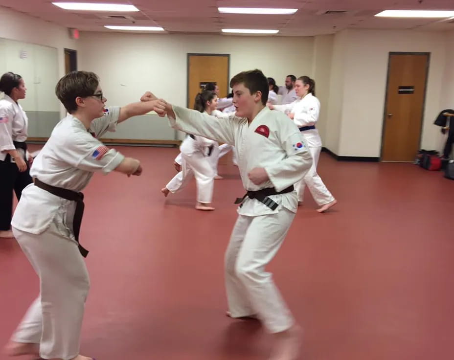 a group of people in karate uniforms