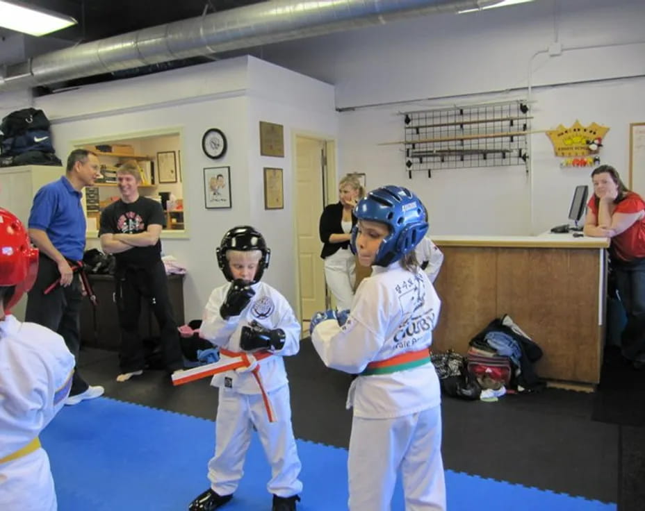 a young boy holding a baseball bat