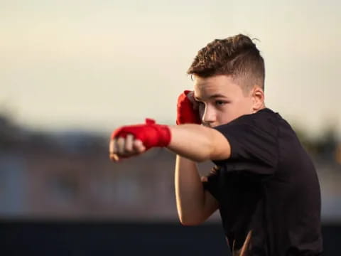 a boy wearing boxing gloves