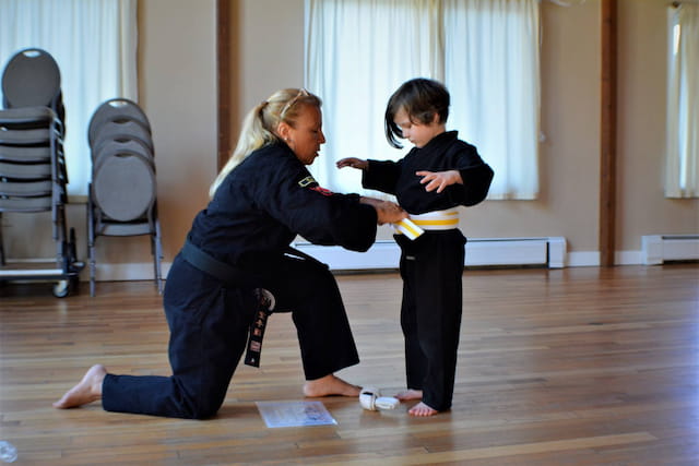 a person and a boy practicing karate