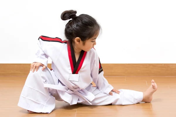 a young girl in a karate uniform