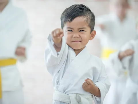 a young boy in a white shirt