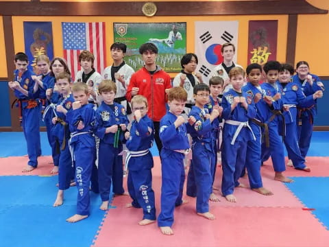 a group of children in blue karate uniforms
