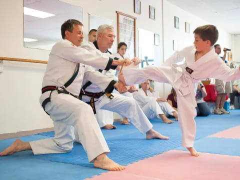 a group of men in karate uniforms