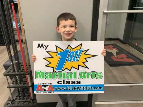 a boy holding a sign