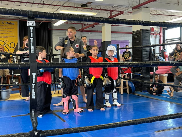 a group of kids in a boxing ring