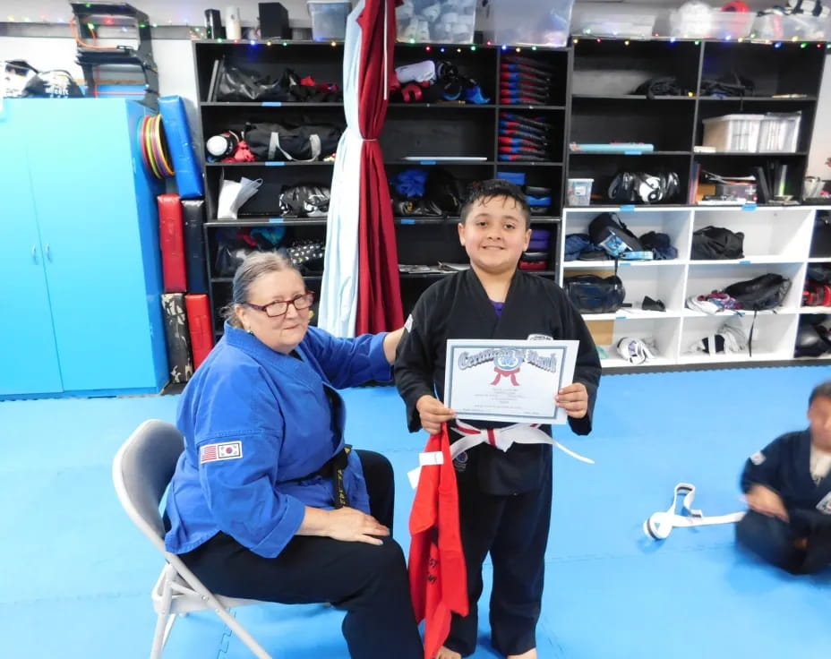 a person and a boy holding a sign
