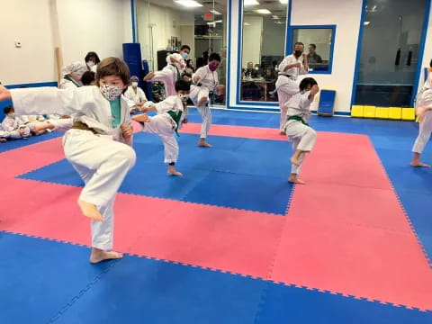 a group of children practicing karate