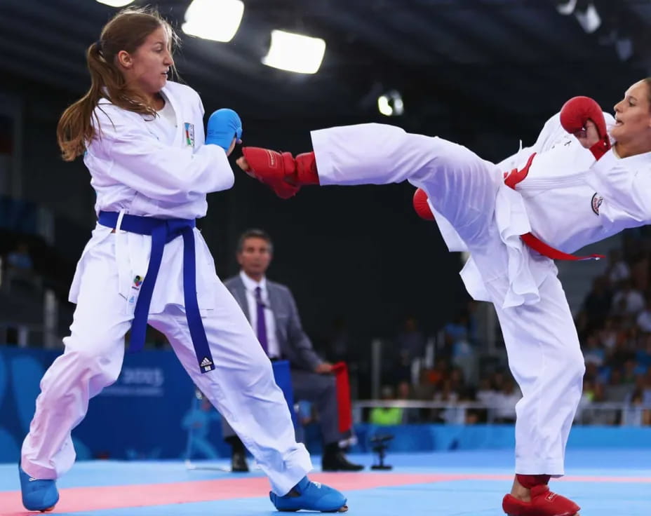 a couple of women in karate uniforms