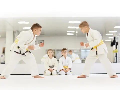 a group of people in karate uniforms