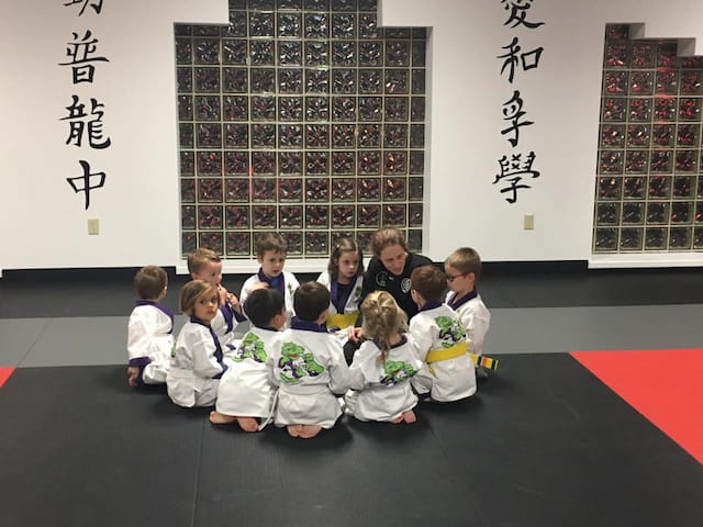a group of children sitting in a classroom