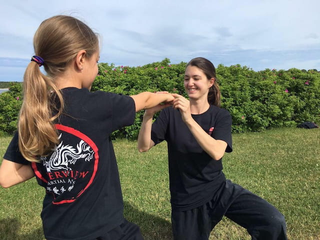 two women sitting on grass