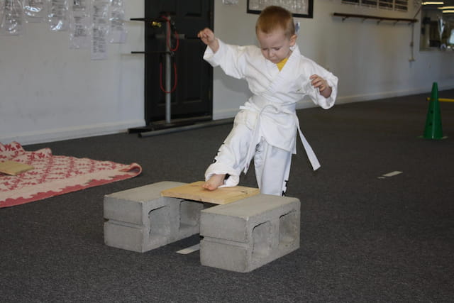 a boy in a white suit