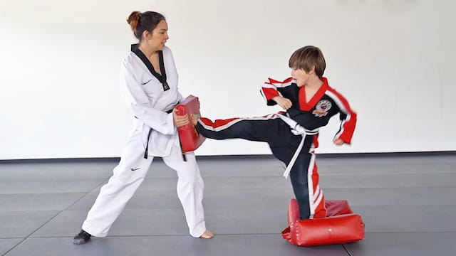 a person and a boy in karate uniforms