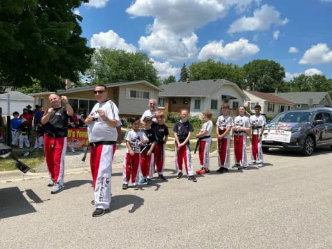 a group of people standing in a parking lot