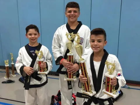 a group of boys holding trophies