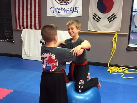 two boys sitting on a blue chair