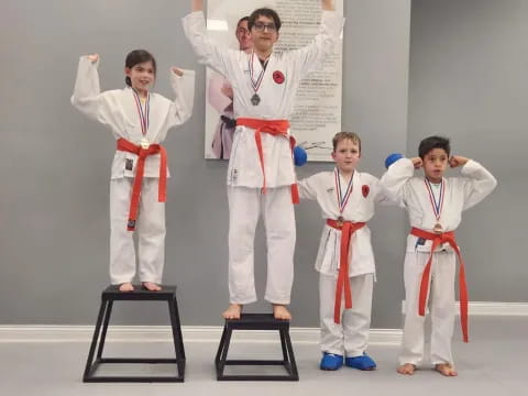 a group of people in white karate uniforms