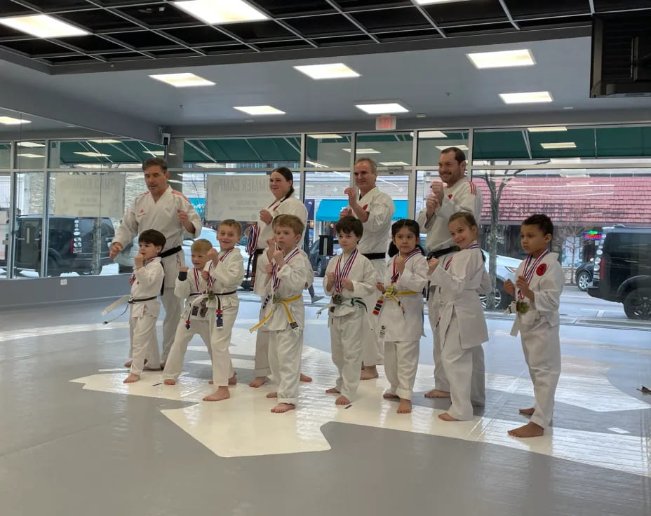 a group of people wearing white karate uniforms