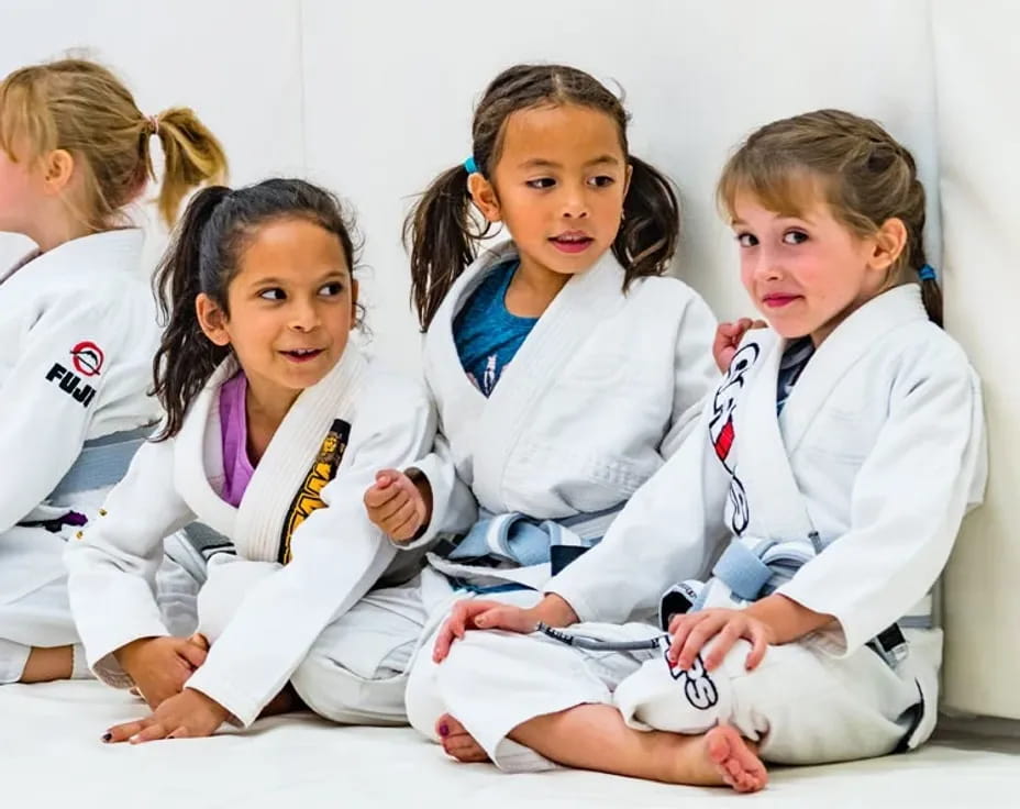 a group of girls in white uniforms