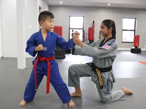 a person and a boy in karate uniforms