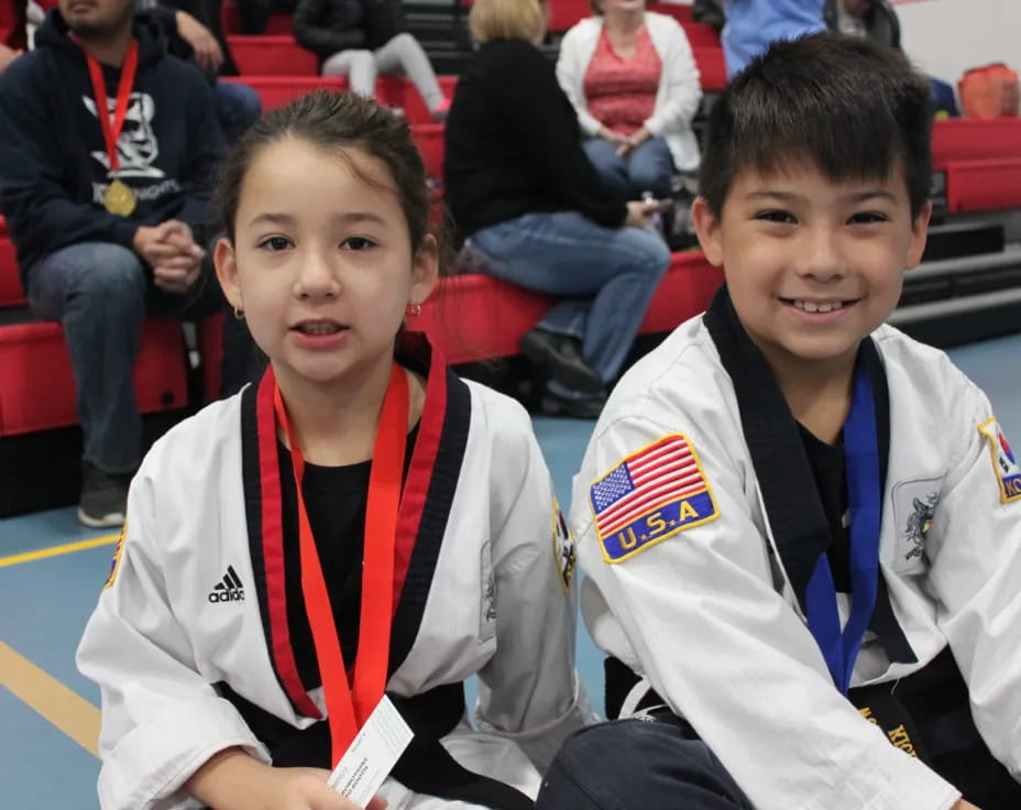 a couple of boys wearing medals