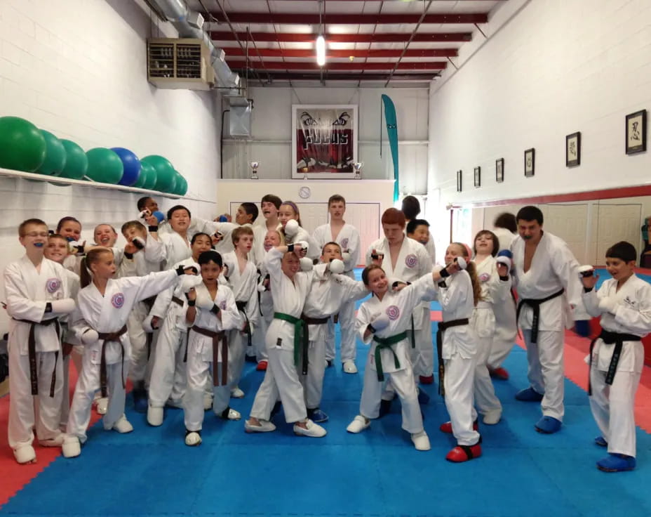 a group of people in white karate uniforms