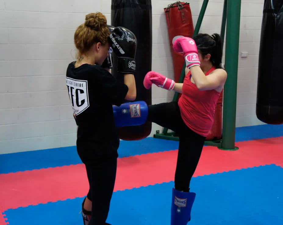 a couple of women in boxing gloves