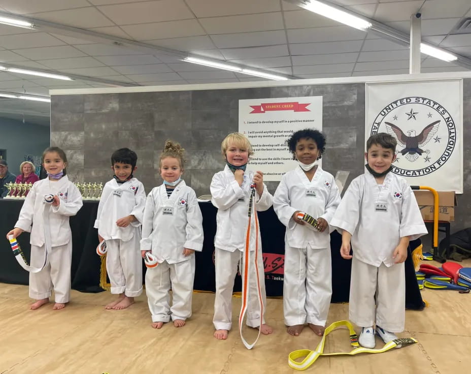 a group of kids in karate uniforms