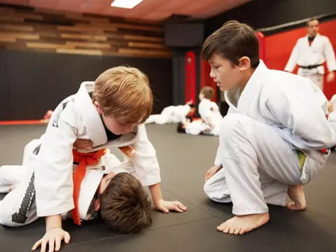 a few boys in karate uniforms