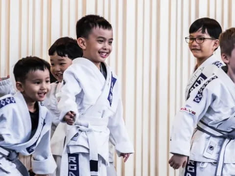 a group of boys in white karate uniforms