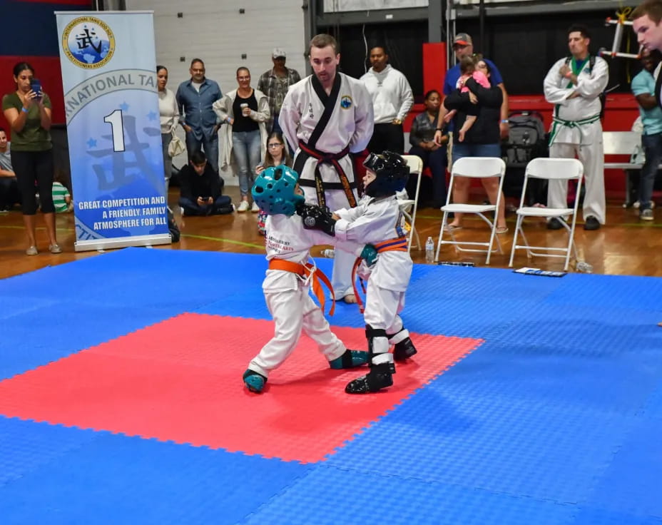a couple of kids in karate uniforms