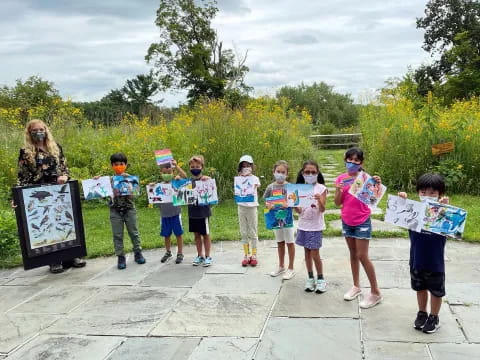 a group of children holding books
