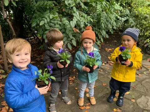 a group of children holding flowers