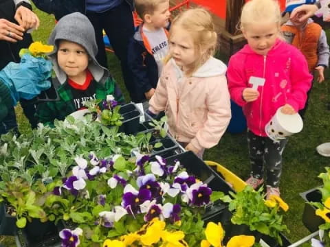 a group of children looking at flowers