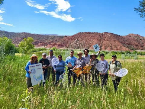 a group of people posing for a photo in a field