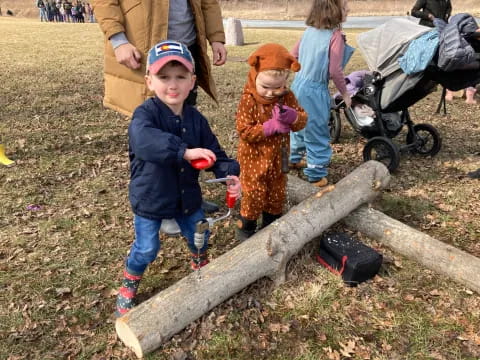 a boy and a girl on a log