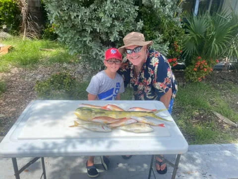 a man and a boy holding a fish