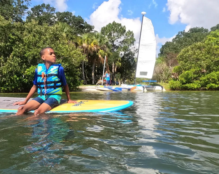 a person sitting on a surfboard