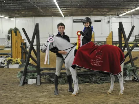 a person and a boy on a horse