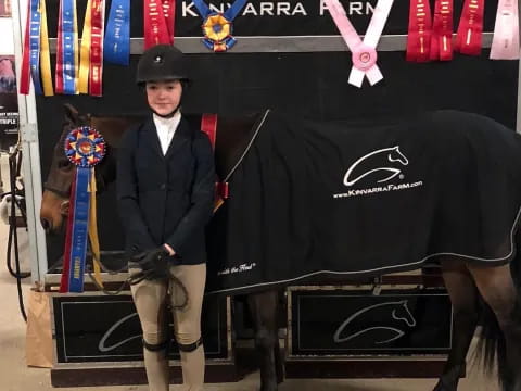 a person standing next to a horse