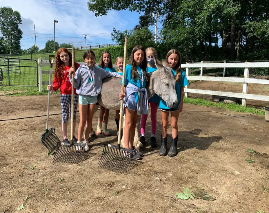 a group of girls holding shovels