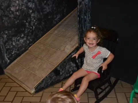 a little girl sitting in a chair