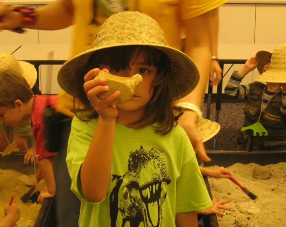 a young boy eating a banana