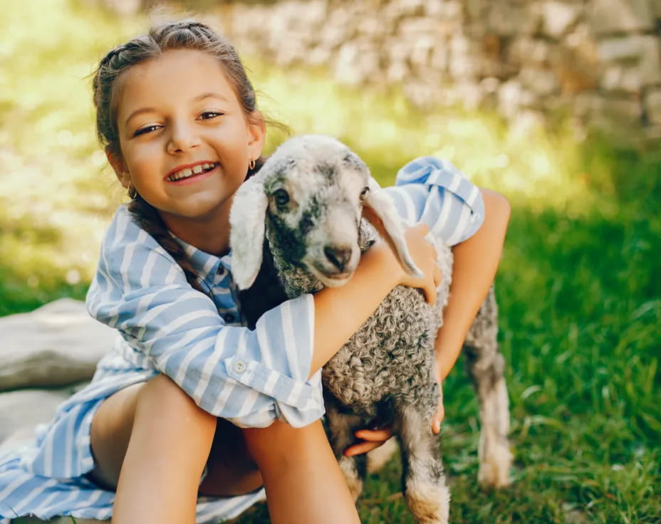 a child holding a dog