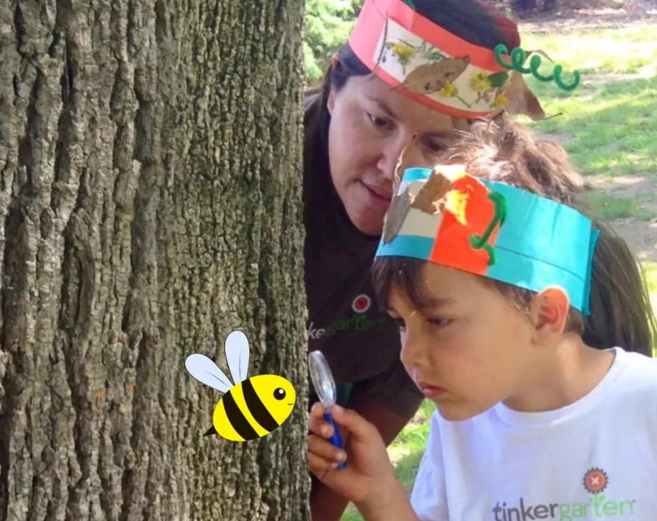 a girl and a boy looking at a tree