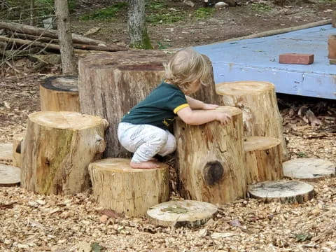 a child playing with a wooden bench