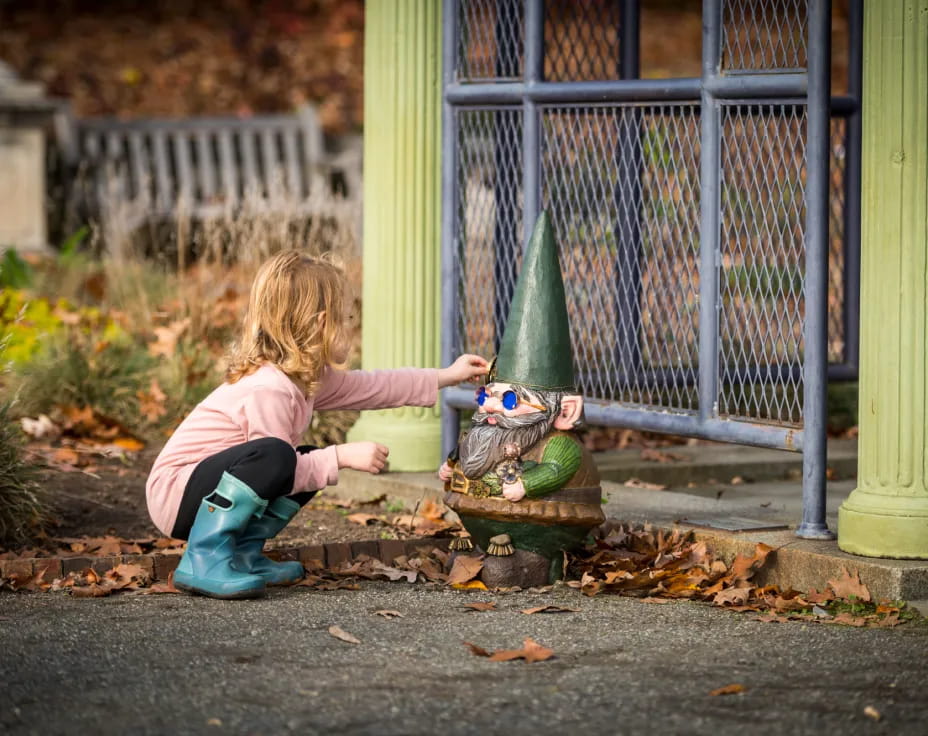 a girl playing with a toy frog