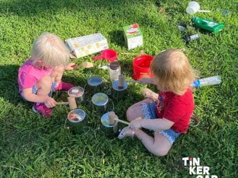 two girls sitting in the grass