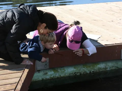 a person and two children on a dock